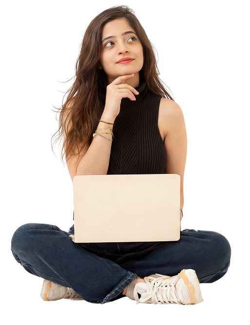 Fatima sitting cross-legged with a laptop, looking up and thinking